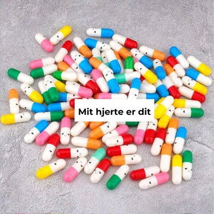 Kapseln mit Nachricht in Geschenkflasche